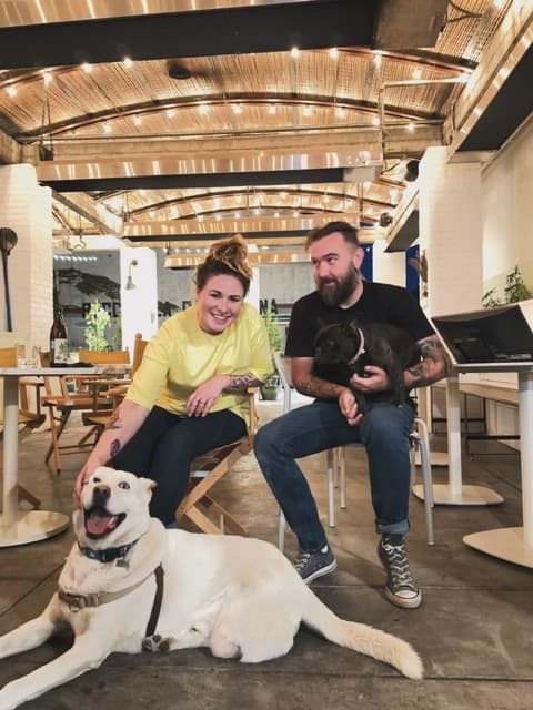 Jonny and his wife Tiffany seated with their two dogs